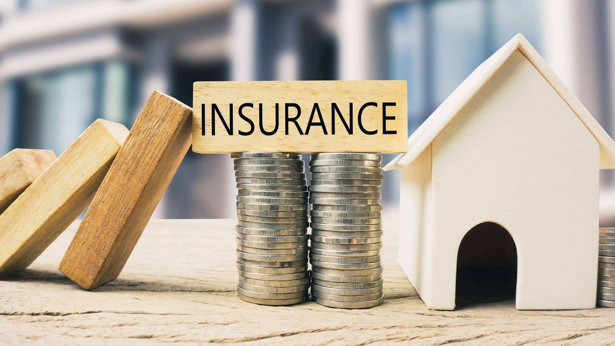 home-insurance-coverage-for-plumbing-picture-of-toy-house-and-a-stack-of-coins