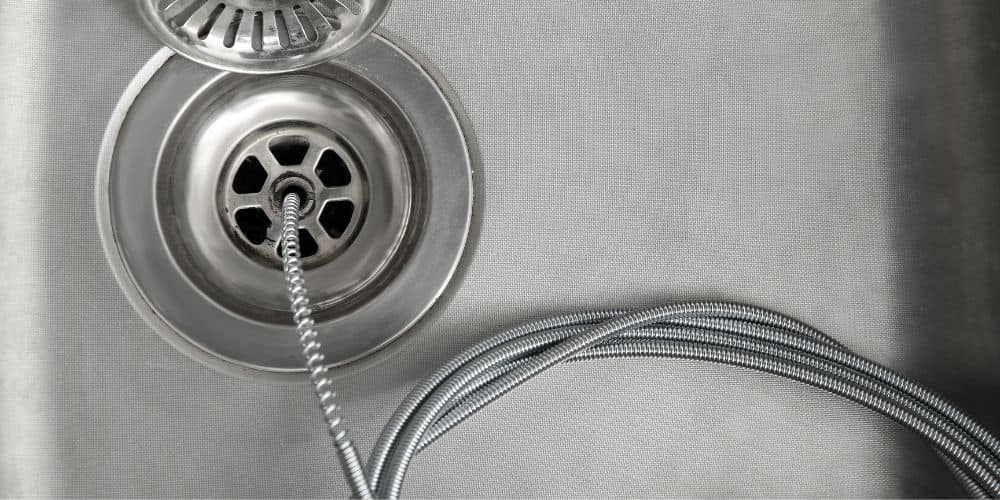 An overhead, close-up view of a metal plumbing snake