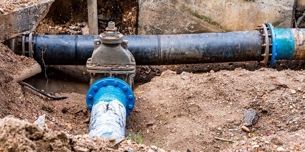 black trenchless pipe running horizontally