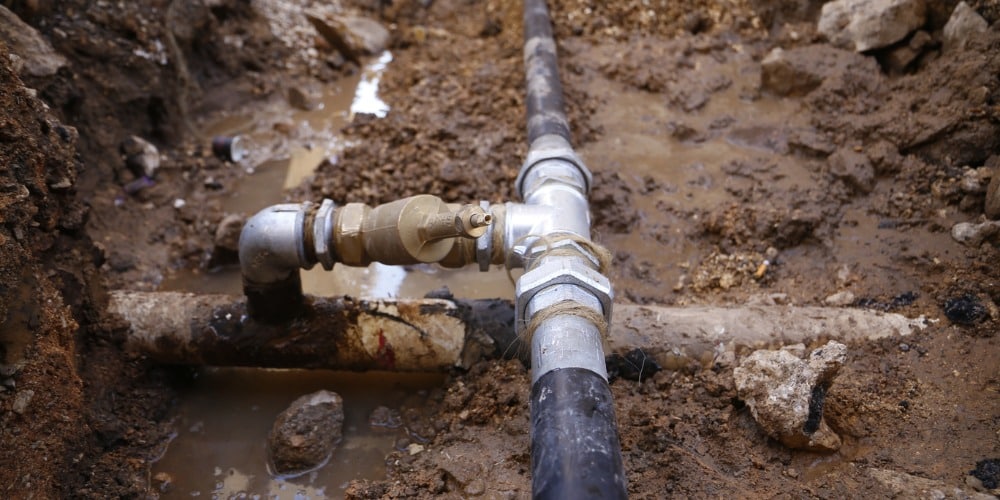 exposed underground water main connection