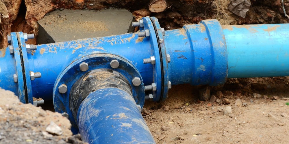 large blue flanged T-junction pipe connection