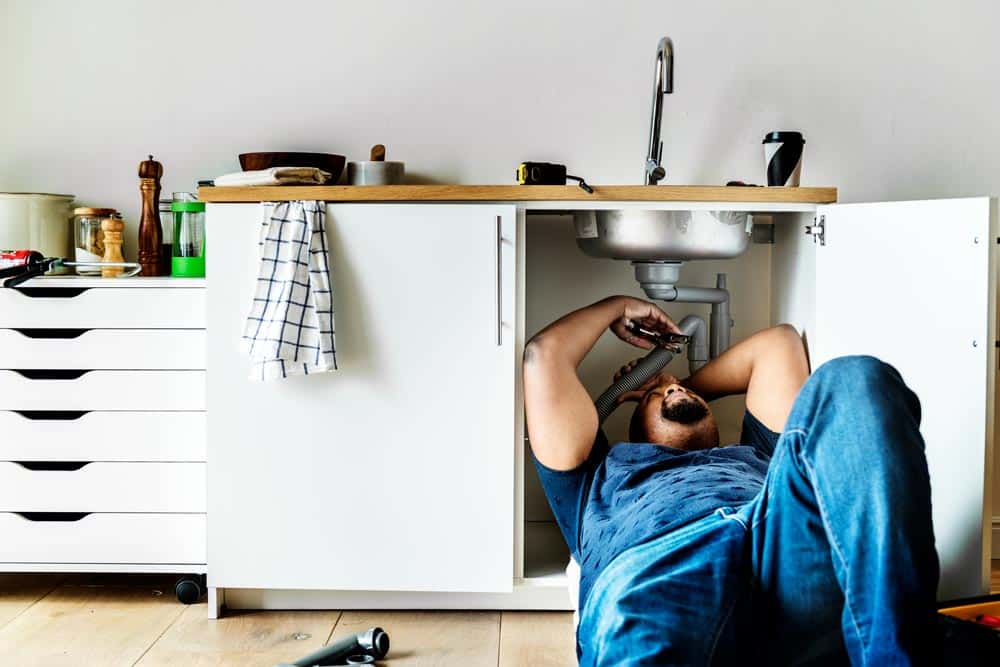 plumber man fixing kitchen sink